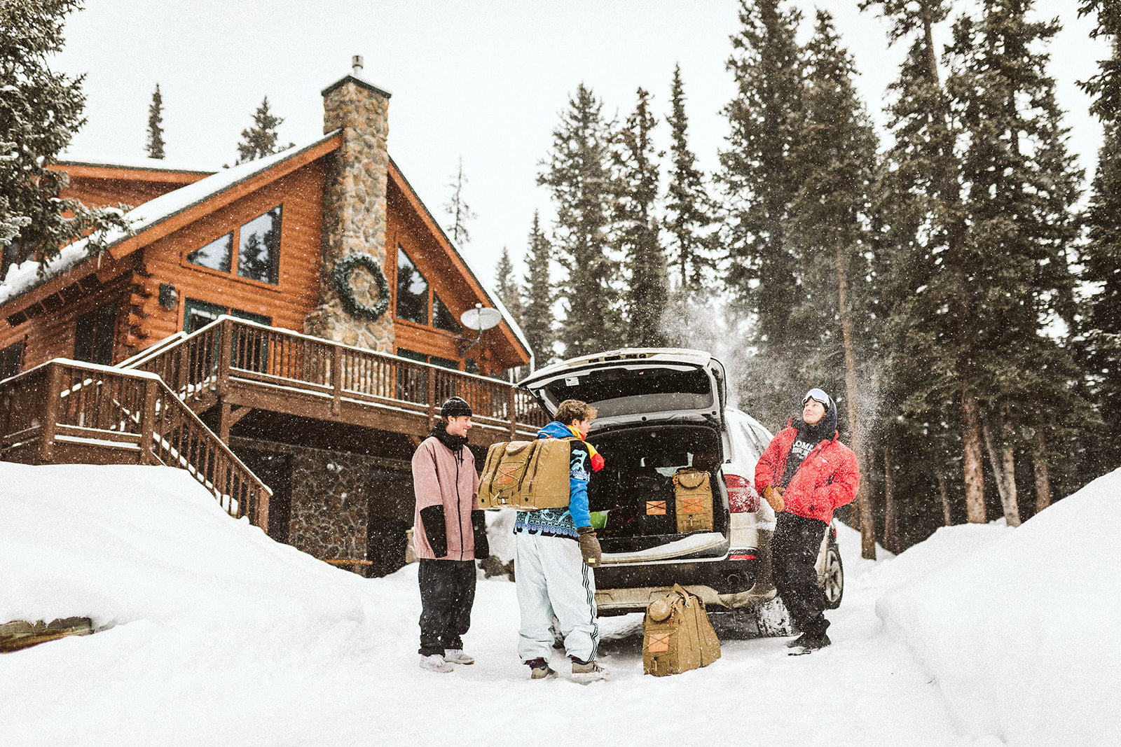 outdoor skiers packing Switch skiboot bags into car